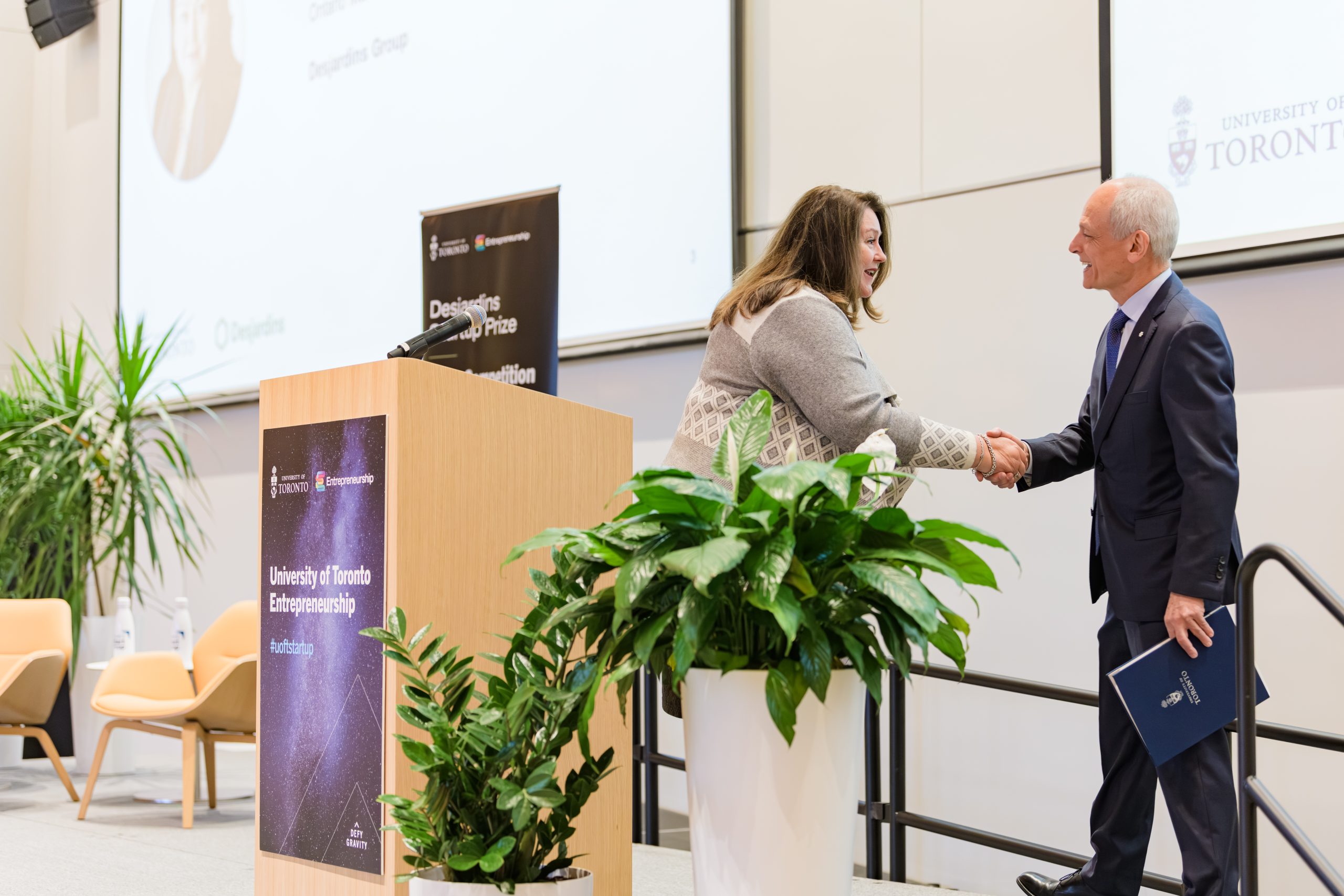 Senior Vice President, Market Growth, Brand Expansion, and Partner Relations, Desjardins Group shakes hands with U of T President Meric Gertler at the Desjardins Startup Prize